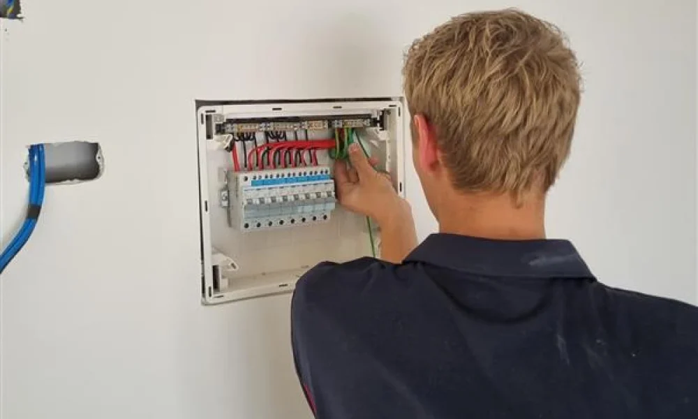 Electrician working on a switchboard installation, ensuring a safe and efficient electrical system.