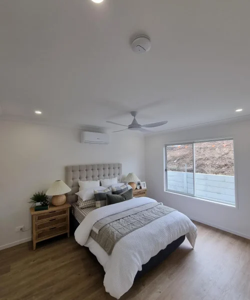 Bedroom with ceiling fan and electrical fitout completed for a Queensland home