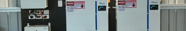 Two stacked Deye battery units and a Deye inverter installed on a wall